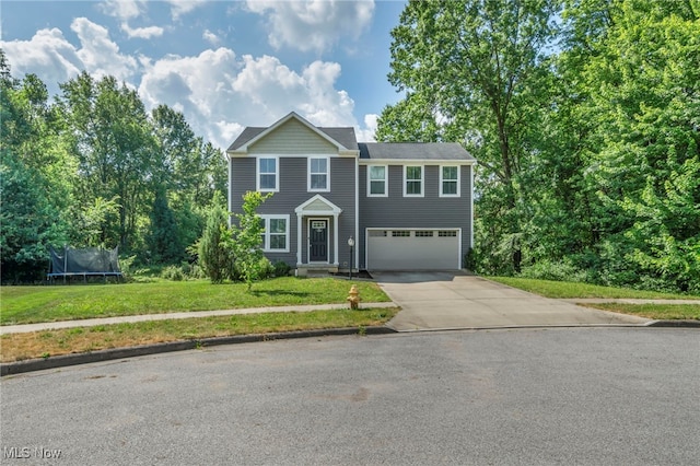 301 Karson Dr, Akron, OH 44312 - view of front of house with a trampoline, driveway, a garage, and a front lawn