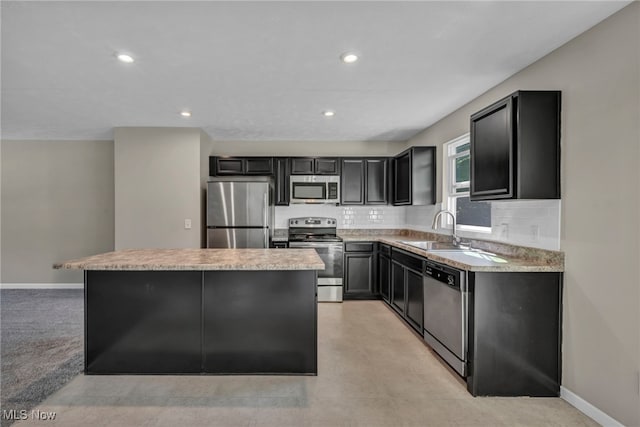 301 Karson Dr, Akron, OH 44312 - kitchen with stainless steel appliances, a center island, dark cabinets, backsplash, and light countertops