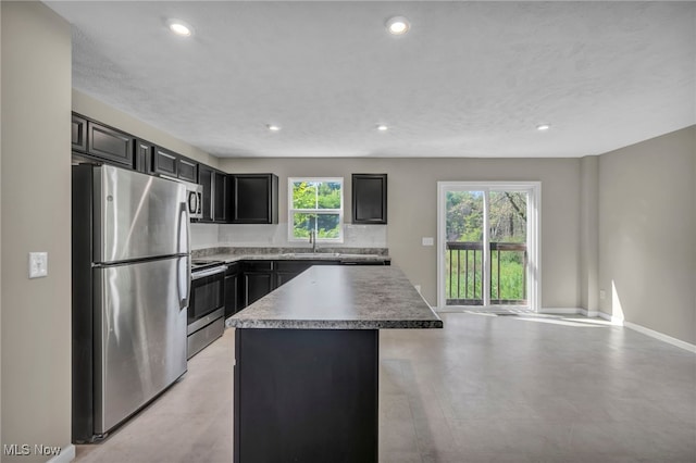 301 Karson Dr, Akron, OH 44312 - kitchen featuring stainless steel appliances, a center island, recessed lighting, open floor plan, and dark cabinets