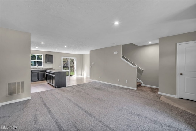 301 Karson Dr, Akron, OH 44312 - unfurnished living room featuring recessed lighting, light colored carpet, and stairs
