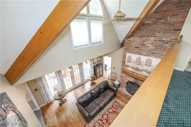 3043 E Wallings Rd, Broadview Heights, OH 44147 - living area featuring high vaulted ceiling, a fireplace, ceiling fan, wood finished floors, and french doors