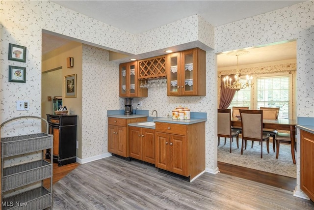 3043 E Wallings Rd, Broadview Heights, OH 44147 - indoor bar featuring wallpapered walls, dark wood-style floors, a chandelier, and decorative light fixtures