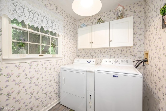 3043 E Wallings Rd, Broadview Heights, OH 44147 - laundry room with cabinet space, washing machine and dryer, wallpapered walls, wood finished floors, and healthy amount of natural light
