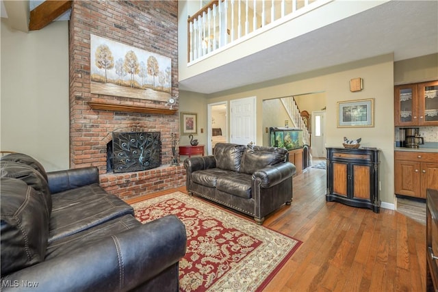3043 E Wallings Rd, Broadview Heights, OH 44147 - living room with wood finished floors, a fireplace, and a high ceiling