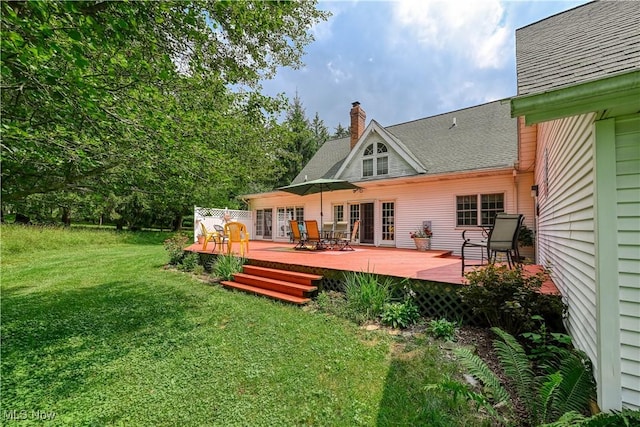3043 E Wallings Rd, Broadview Heights, OH 44147 - rear view of house featuring a chimney, a lawn, a shingled roof, and a deck