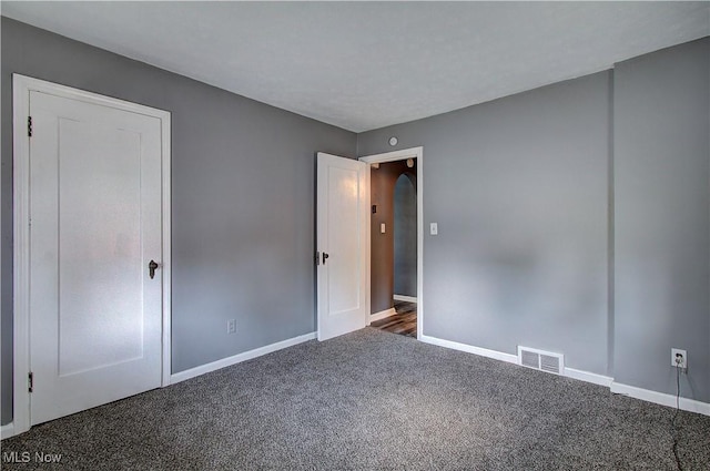 1648 Frederick Ave SW, Canton, OH 44706 - unfurnished bedroom featuring carpet flooring and arched walkways