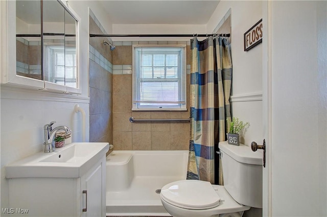 1648 Frederick Ave SW, Canton, OH 44706 - bathroom featuring vanity, a shower with shower curtain, and tile walls