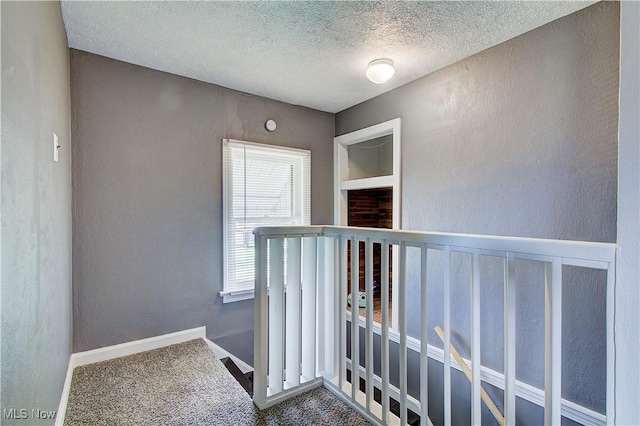 1648 Frederick Ave SW, Canton, OH 44706 - hall with carpet, a textured ceiling, an upstairs landing, and a textured wall
