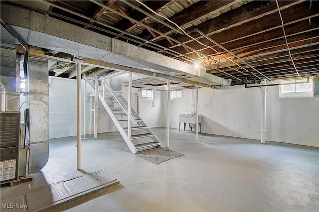 1648 Frederick Ave SW, Canton, OH 44706 - basement featuring stairs, plenty of natural light, heating unit, and concrete block wall