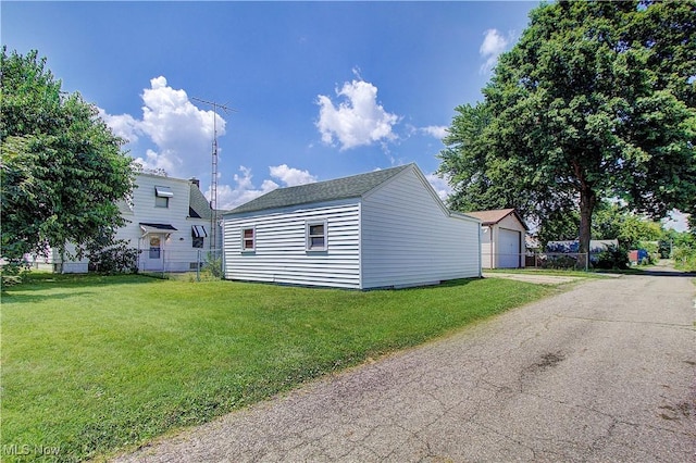 1648 Frederick Ave SW, Canton, OH 44706 - view of side of property featuring an outbuilding, a lawn, and a detached garage