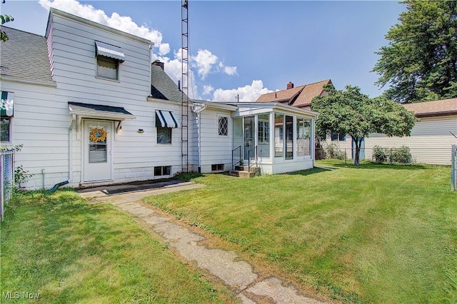 1648 Frederick Ave SW, Canton, OH 44706 - rear view of house with a yard, roof with shingles, entry steps, and a sunroom