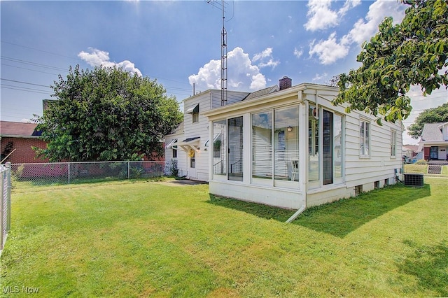 1648 Frederick Ave SW, Canton, OH 44706 - rear view of house featuring a fenced backyard, a chimney, and a sunroom