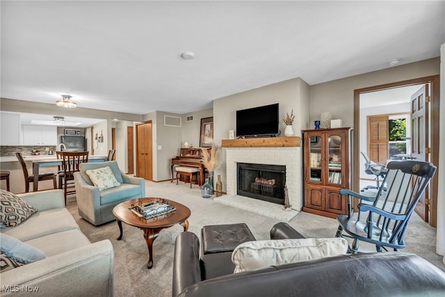 255 Portage Lakes Dr Unit E, Akron, OH 44319 - living room featuring carpet and a fireplace