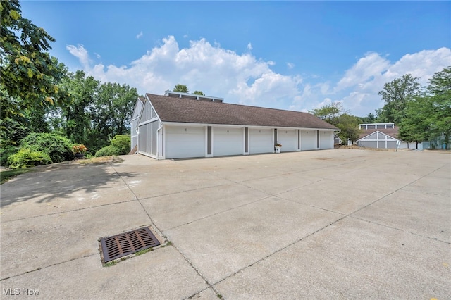 255 Portage Lakes Dr Unit E, Akron, OH 44319 - view of home's exterior with community garages and roof with shingles