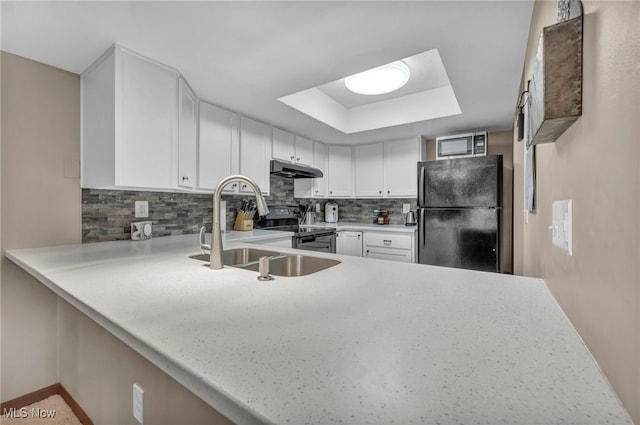 255 Portage Lakes Dr Unit E, Akron, OH 44319 - kitchen featuring freestanding refrigerator, electric range, under cabinet range hood, stainless steel microwave, and a raised ceiling