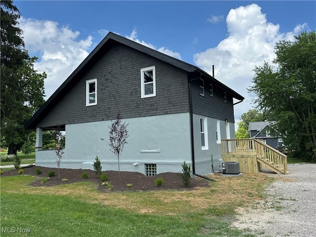 26 E Satin St, Jefferson, OH 44047 - view of side of property with stucco siding and a lawn