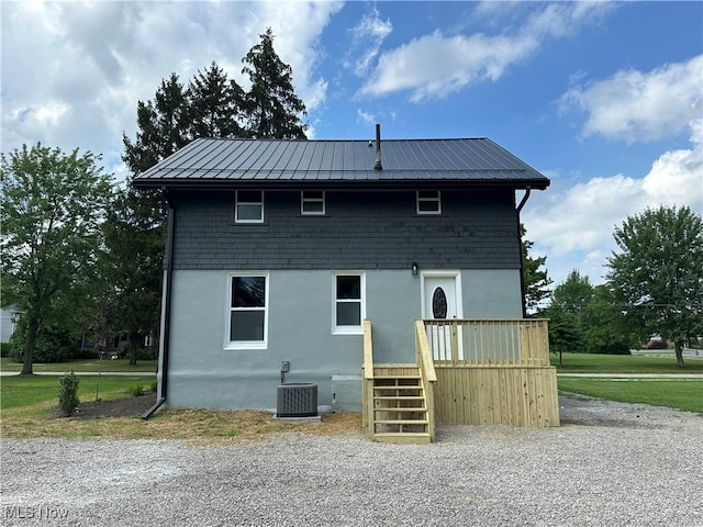 26 E Satin St, Jefferson, OH 44047 - rear view of property featuring a metal roof, a standing seam roof, and stucco siding