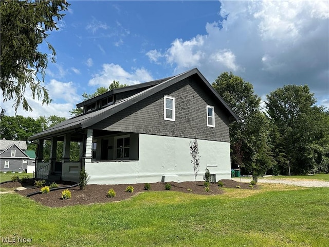 26 E Satin St, Jefferson, OH 44047 - view of home's exterior featuring a yard and stucco siding