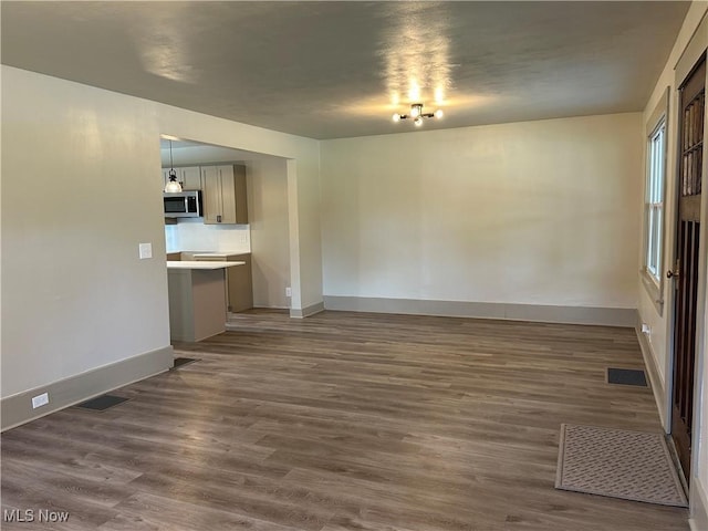 26 E Satin St, Jefferson, OH 44047 - unfurnished living room featuring dark wood-type flooring