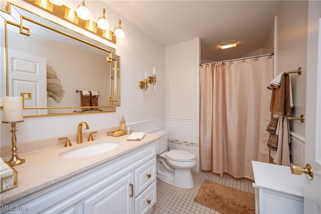 117 Nicklaus Dr NE, Warren, OH 44484 - full bath featuring vanity, tile patterned flooring, wainscoting, tile walls, and a shower with shower curtain