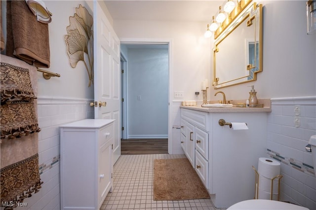 117 Nicklaus Dr NE, Warren, OH 44484 - bathroom with tile walls, vanity, wainscoting, and tile patterned floors