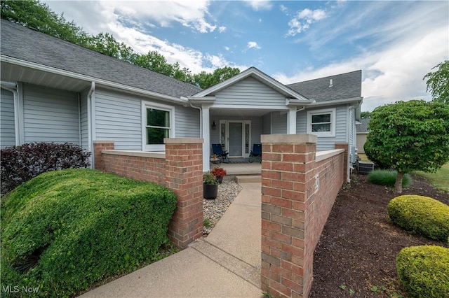 117 Nicklaus Dr NE, Warren, OH 44484 - view of front facade with covered porch, roof with shingles, and brick siding
