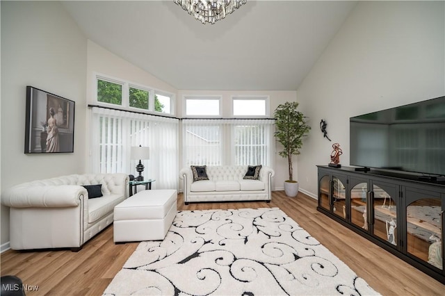 117 Nicklaus Dr NE, Warren, OH 44484 - living area featuring high vaulted ceiling, light wood-style flooring, and a chandelier