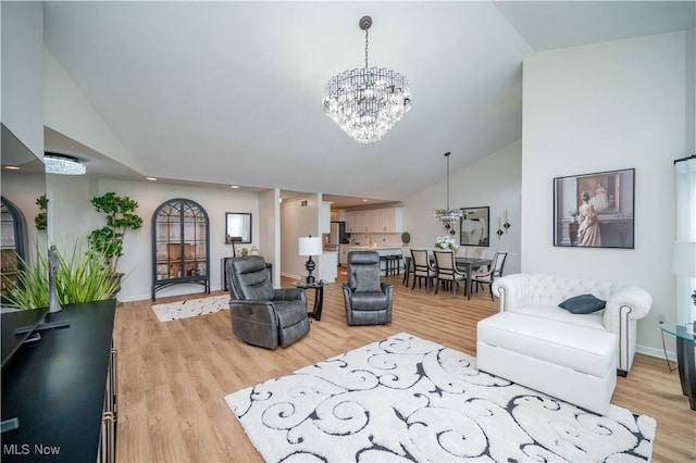117 Nicklaus Dr NE, Warren, OH 44484 - living room with a chandelier, light wood-style floors, recessed lighting, and high vaulted ceiling