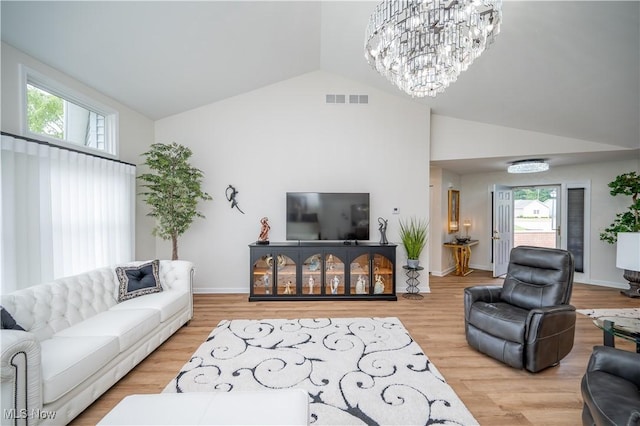 117 Nicklaus Dr NE, Warren, OH 44484 - living room featuring a chandelier, wood finished floors, and high vaulted ceiling