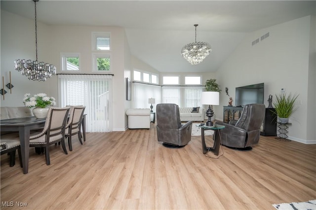 117 Nicklaus Dr NE, Warren, OH 44484 - living room with a chandelier, high vaulted ceiling, and wood finished floors