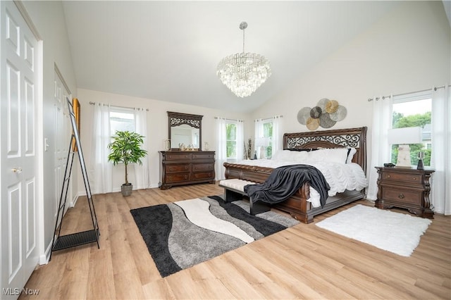 117 Nicklaus Dr NE, Warren, OH 44484 - bedroom featuring high vaulted ceiling, a chandelier, light wood-type flooring, and multiple windows