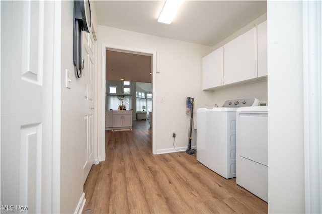 117 Nicklaus Dr NE, Warren, OH 44484 - laundry room featuring cabinet space, independent washer and dryer, and light wood-type flooring