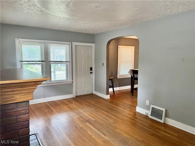 667 Eastland Ave, Akron, OH 44305 - foyer with arched walkways, hardwood / wood-style floors, and a textured ceiling