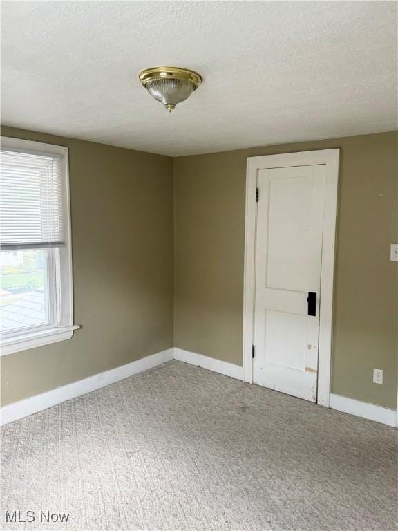 667 Eastland Ave, Akron, OH 44305 - carpeted spare room with a textured ceiling