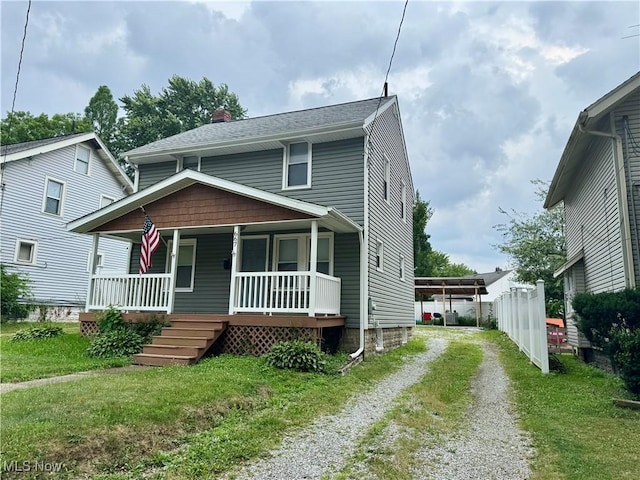 667 Eastland Ave, Akron, OH 44305 - view of front of house featuring driveway, covered porch, a chimney, and a front lawn
