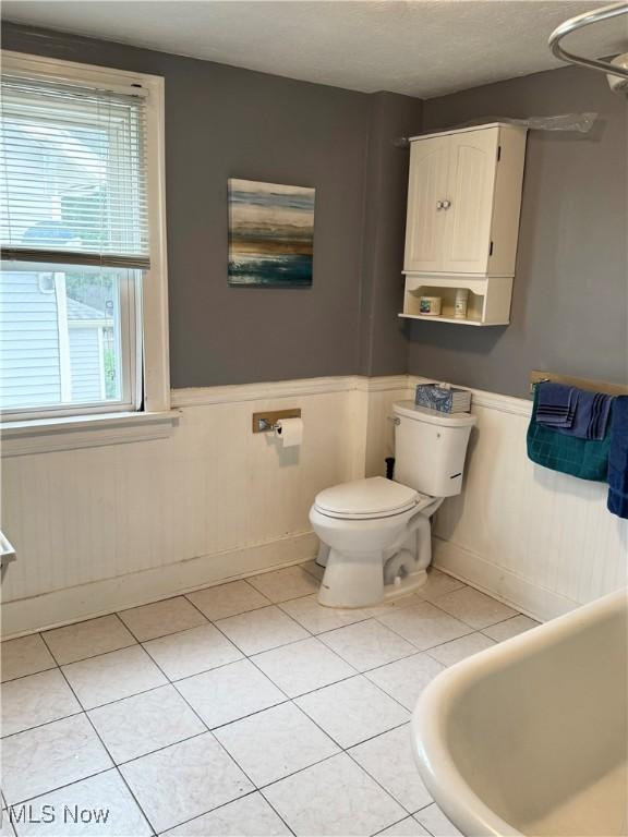 667 Eastland Ave, Akron, OH 44305 - bathroom featuring wainscoting and tile patterned floors