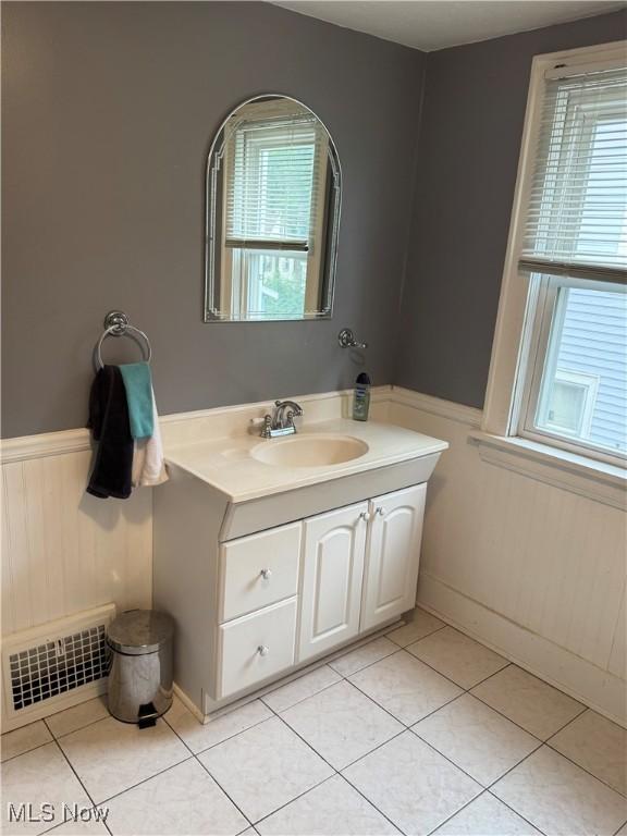 667 Eastland Ave, Akron, OH 44305 - bathroom with wainscoting, vanity, and tile patterned flooring