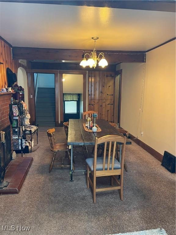 717 Calla Rd E, Poland, OH 44514 - carpeted dining area featuring a chandelier and a fireplace