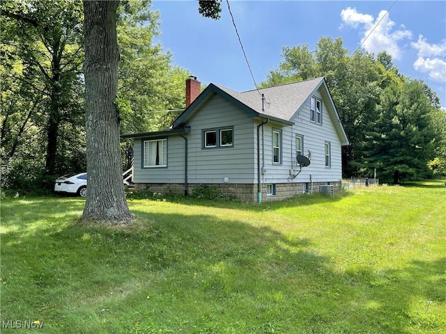 717 Calla Rd E, Poland, OH 44514 - view of side of property featuring a chimney and a yard