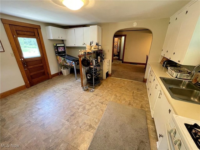 717 Calla Rd E, Poland, OH 44514 - kitchen with arched walkways, white cabinets, and light countertops