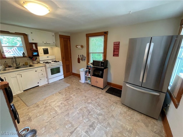 717 Calla Rd E, Poland, OH 44514 - kitchen featuring appliances with stainless steel finishes, under cabinet range hood, plenty of natural light, and decorative backsplash