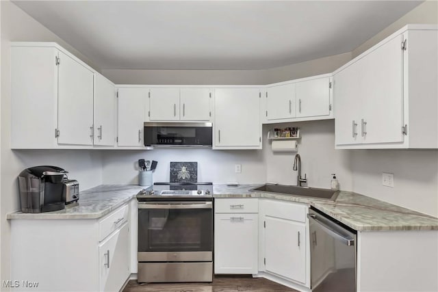 1851 King James Unit 322, Westlake, OH 44145 - kitchen featuring stainless steel appliances, light countertops, dark wood-style floors, and white cabinets