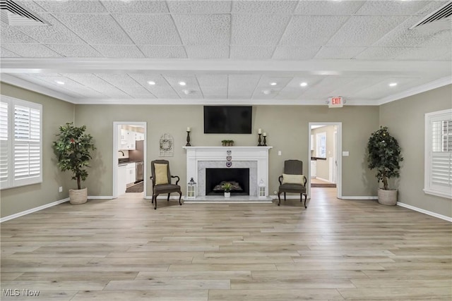 1851 King James Unit 322, Westlake, OH 44145 - living area featuring light wood-style floors, crown molding, recessed lighting, plenty of natural light, and a fireplace