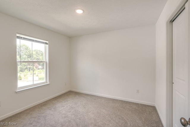 677 Crossings Ln, Akron, OH 44320 - unfurnished room with carpet floors, a textured ceiling, and recessed lighting
