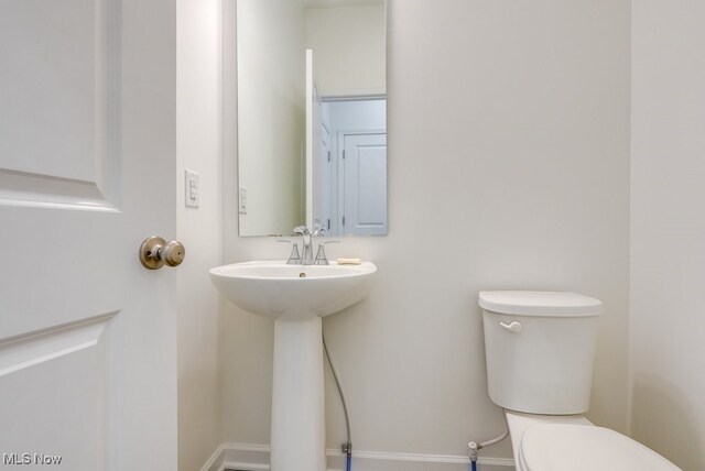 677 Crossings Ln, Akron, OH 44320 - half bathroom with toilet and baseboards