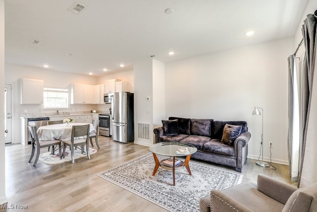 677 Crossings Ln, Akron, OH 44320 - living room featuring light wood-style flooring and recessed lighting