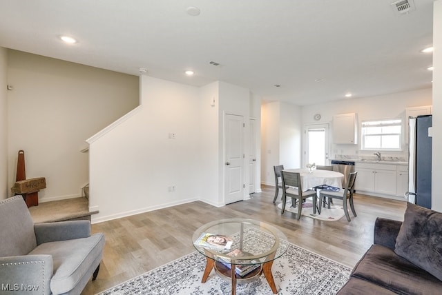 677 Crossings Ln, Akron, OH 44320 - living area featuring light wood-style flooring, recessed lighting, and stairs