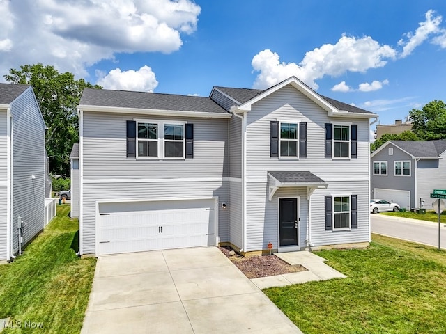 677 Crossings Ln, Akron, OH 44320 - traditional-style house featuring concrete driveway, a garage, and a front yard