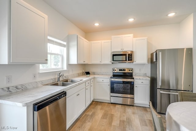 677 Crossings Ln, Akron, OH 44320 - kitchen featuring stainless steel appliances, white cabinetry, light countertops, light wood finished floors, and recessed lighting