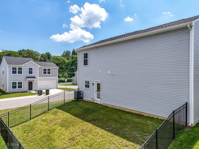 677 Crossings Ln, Akron, OH 44320 - view of property exterior with driveway, a garage, and a fenced backyard